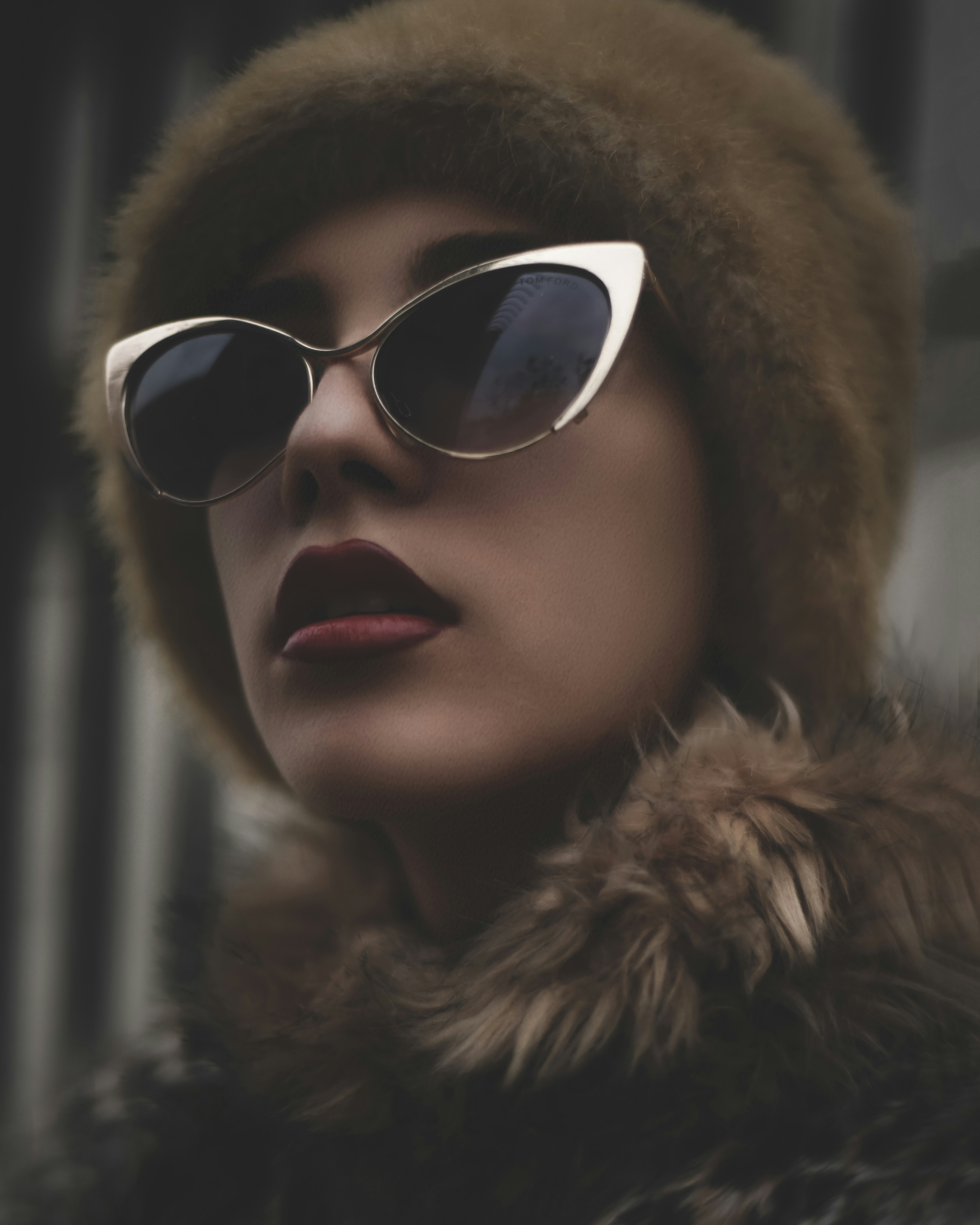 woman wearing black sunglasses with gold-colored frames